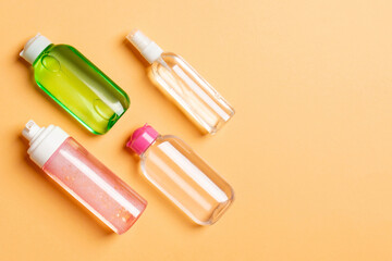 Cosmetics SPA branding mock-up, top view with copy space. set of tubes and jars of cream flat lay on colored background