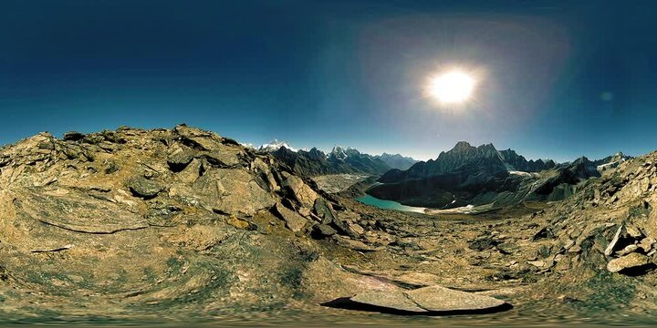 360 VR Gokyo Ri mountain top. Tibetan prayer Buddhist flag. Wild Himalayas high altitude nature and mount valley. Rocky slopes covered with snow and deep blue sky