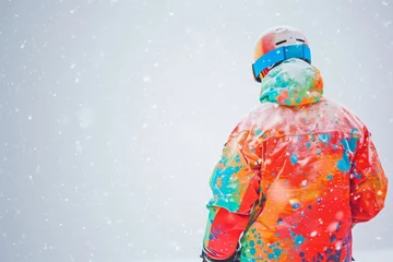 Fototapeten snowboarder wearing a vibrant jacket against a backdrop of white snow © primopiano