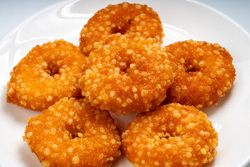 Fried fish donuts on White plate.,