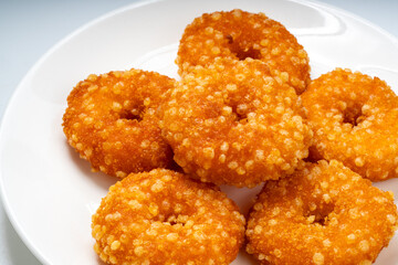 Fried fish donuts on White plate.,