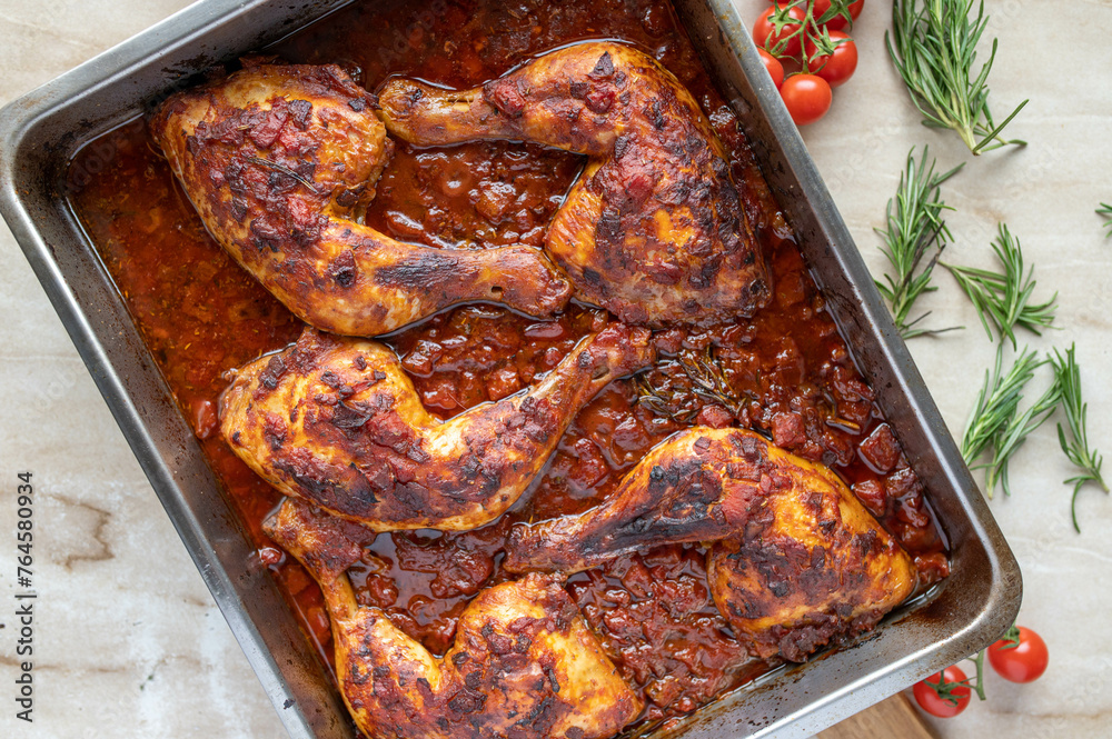 Wall mural Braised chicken legs with italian red wine tomato sauce in a roasting pan