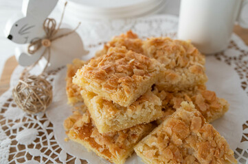 Almond Butter cake with easter decoraten on light table background