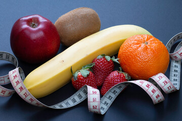 Dietary fruit still life with banana, strawberry, orange, kiwi and apple.