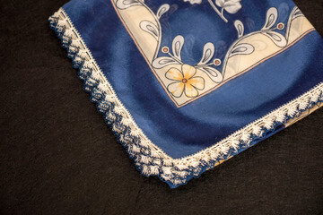 Hand knitted scarf and headscarf samples, handmade embroidered head scarf close-up.