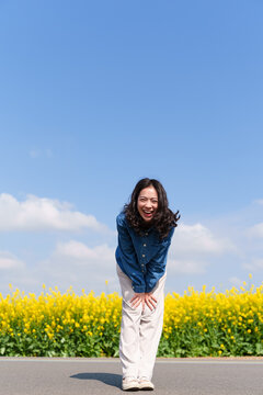 happy young asian woman smile at camera in the sunny spring day
