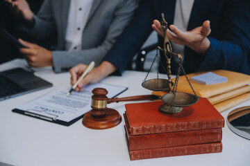 Consultation and conference of Male lawyers and professional businesswoman working and discussion having at law firm in office. Concepts of law, Judge gavel with scales of justice.