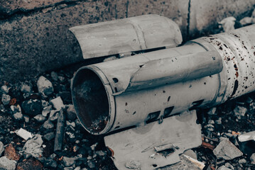 weapon rocket lying on the ground near the wall in Ukraine