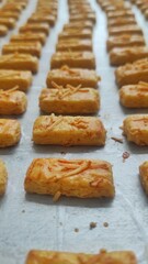 A group of small cheese cookies from Indonesia called 'Kastengel' after baking process, fresh from oven