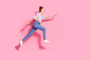 Full length photo of optimistic red hair young woman jump flying trying catch coupon for sale...