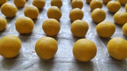 A group of small round cookies stuffed with pineapple jam from Indonesia called 'Nastar' before baked