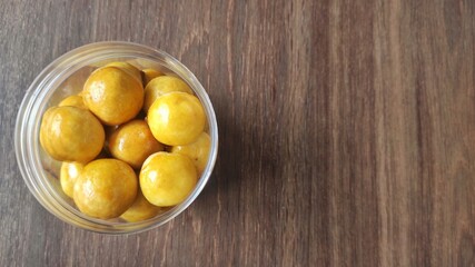 A group of small round cookies stuffed with pineapple jam from Indonesia called 'Nastar' in the jar 