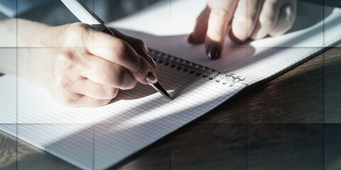 Woman writing on notebook, geometric pattern
