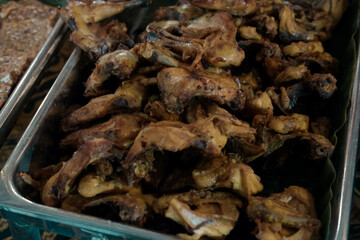 pile of fried fish stacked in a baking dish. buffet food