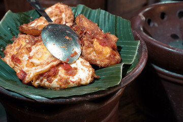 Balado fried eggs served on banana leaves