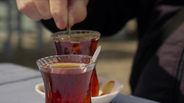 Mixing the Turkish Tea with Spoon