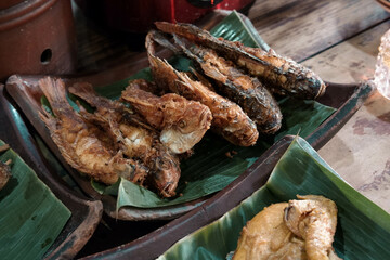 Buffet fried fish in a traditional restaurant with a Javanese joglo house concept