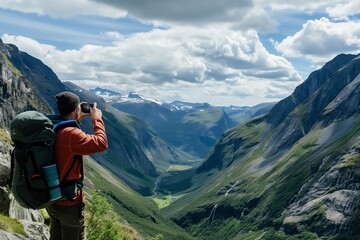 Fototapeta na wymiar hiker taking photo of valley from high vantage point
