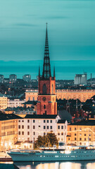 Stockholm, Sweden. Scenic View Of Stockholm Skyline At Summer Evening. Famous Popular Destination Scenic Place In Dusk Lights. Riddarholm Church In Night Lighting - 764608153