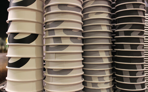 Coffee Intensity Image Concept. Kraft Cardboard Cups For Coffee Stacked In Color From White To Black
