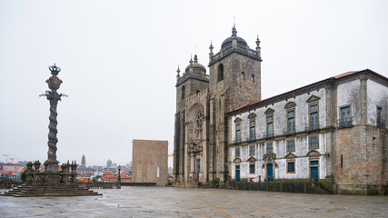 The twisted pillar of Porto and front view of cathedral in Porto, Portugal, on an overcast day