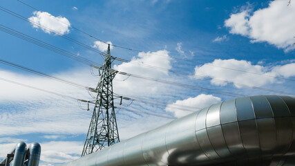 pipeline and power lines against a blue sky