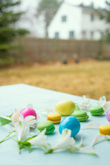 Easter eggs and flower petals on a table in the courtyard of the house. preparation for the celebration of Easter.
