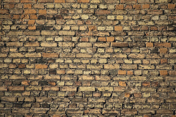 in the photo there is an old brick wall close up