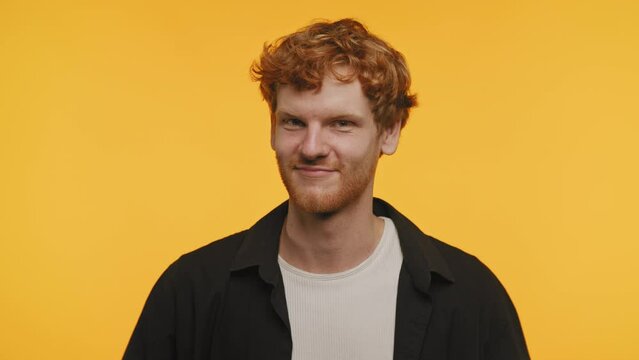 Playful Smirk of a Redhead Man on Yellow