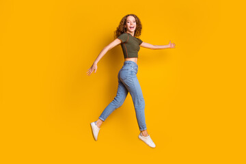 Fototapeta na wymiar Photo of optimistic carefree cheerful girl have fun running traveling isolated on yellow color background