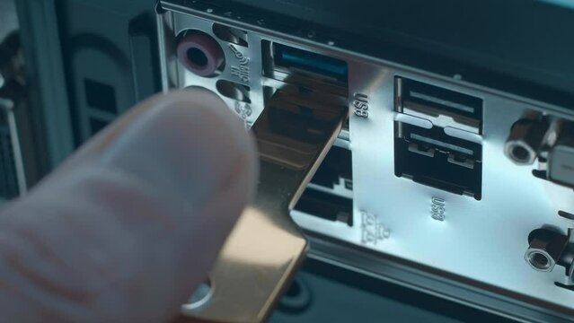 A man's hand inserts and removes USB flash drive in the shape of a golden key into the computer's USB port which provides access to a private Bitcoin wallet as a symbol a carefree and happy life