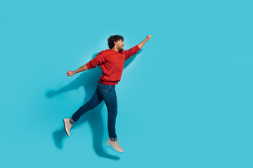 Fototapeta na wymiar Full body size photo of active sportive superhero guy jumping fist up motivated flying to future isolated on aquamarine color background