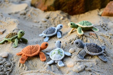 small crocheted toy turtles on a sandy beach setup