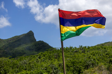 The national flag of Mauritius flutters on the lawn