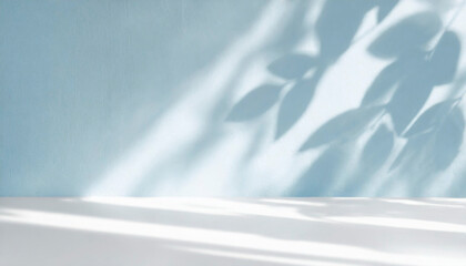 Obraz premium abstract minimal light grunge blue background for product presentation. Shadow and light from windows and from plants on plaster wall for spring or summer presentation of goods