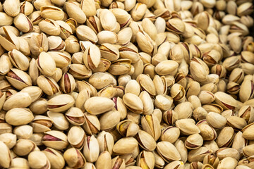 Pistachios with shell, top view. Background of pistachio nuts, whole nut kernels