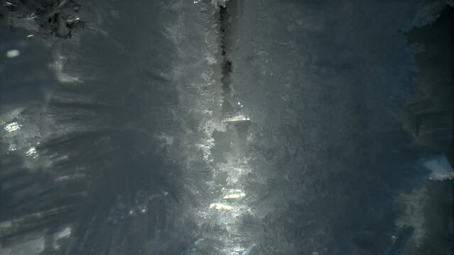 Beautiful crystal icicles, sharp ice snowflakes on stalactites inside cave 