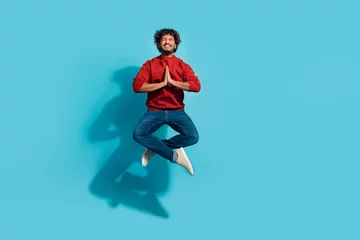 Foto op Plexiglas Full length size photo of guy jumping with clasped palms in lotus pose pleading praying for god help isolated on cyan color background © deagreez