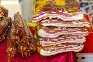 Stack of Smoked Bacon Slabs and Cured Sausages Meat Food