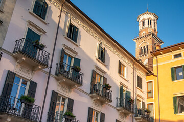 Verona city with a morning view to the church tower and traditional Italian buildings at the foreground