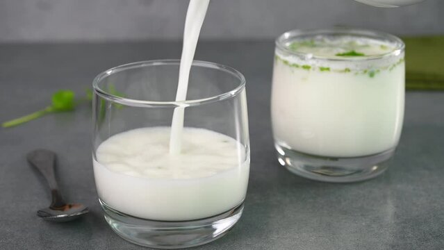Serving buttermilk drink in glass cups.