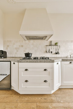 Modern kitchen interior with white cabinetry and gas stove