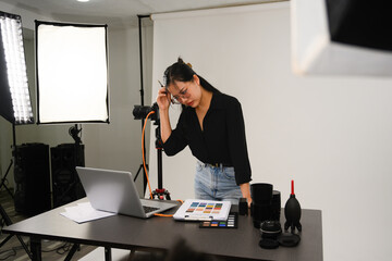 Frustrated female photographer working at her studio