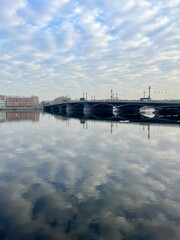 Naklejka premium Amazing bright cloudy sky and buildings reflection at the city river 