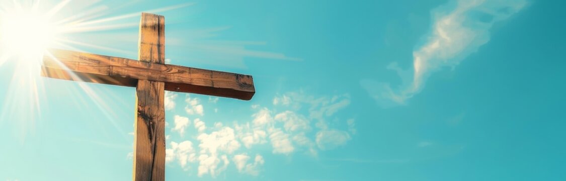 Wooden Cross Against Blue Sky Background with Sun Rays