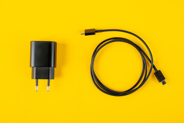USB type c cable and Usb charger isolated on yellow background.