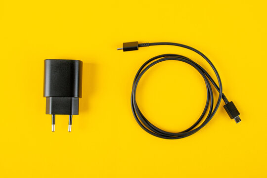 USB type c cable and Usb charger isolated on yellow background.