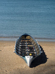 Racing canoe on the sandy beach of the seashore - 764648984