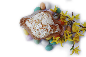 Sweet Easter cake named Colomba Pasquale (Easter dove) with chocolate eggs on white background. Italian traditional pastry 