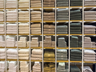 Colorful terry towels on store shelves. Bath towels in shop